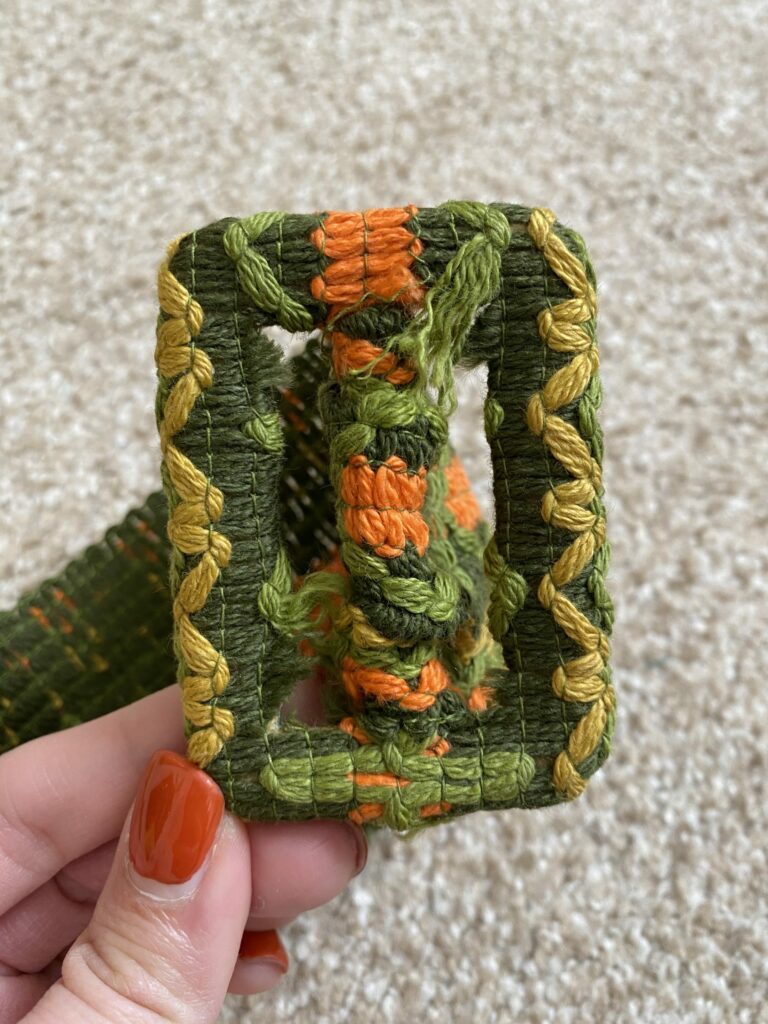 vintage green, yellow, and orange belt