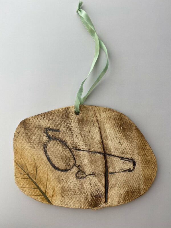 Handmade Hanging Pottery Tile With Feather And Eyeglasses Impressions