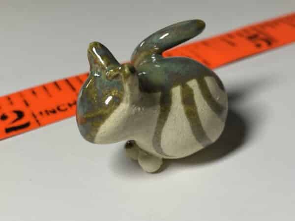 tiny green and white pottery cat