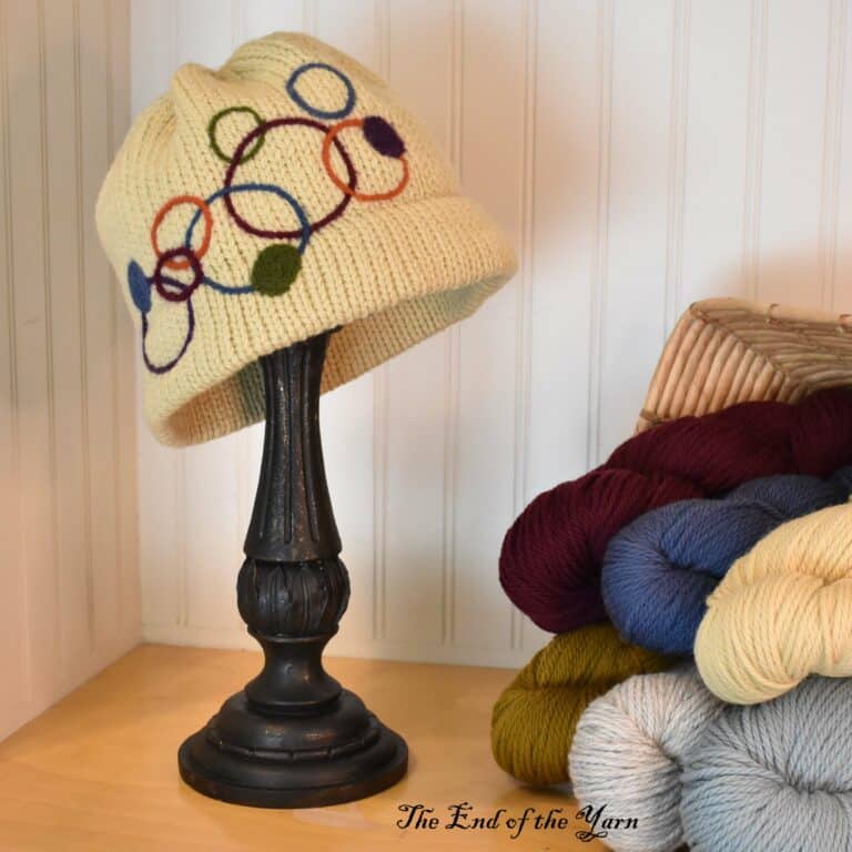 Hat on a stand. Yellow with circle design