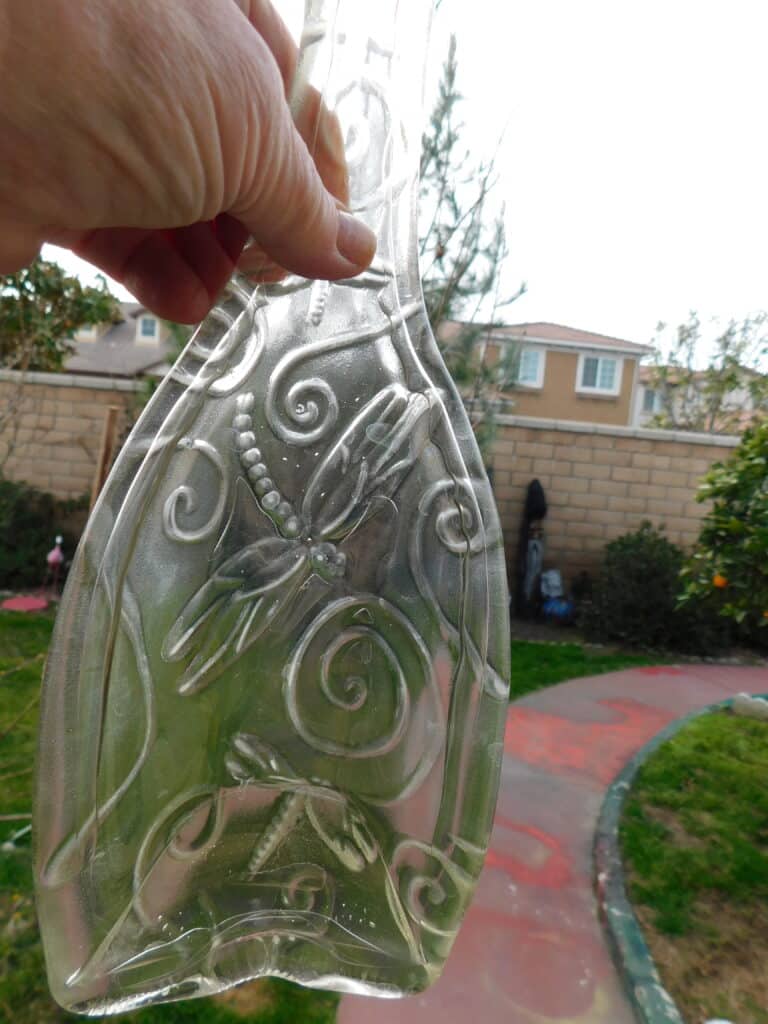 Recycled clear wine bottle in dragonfly pattern