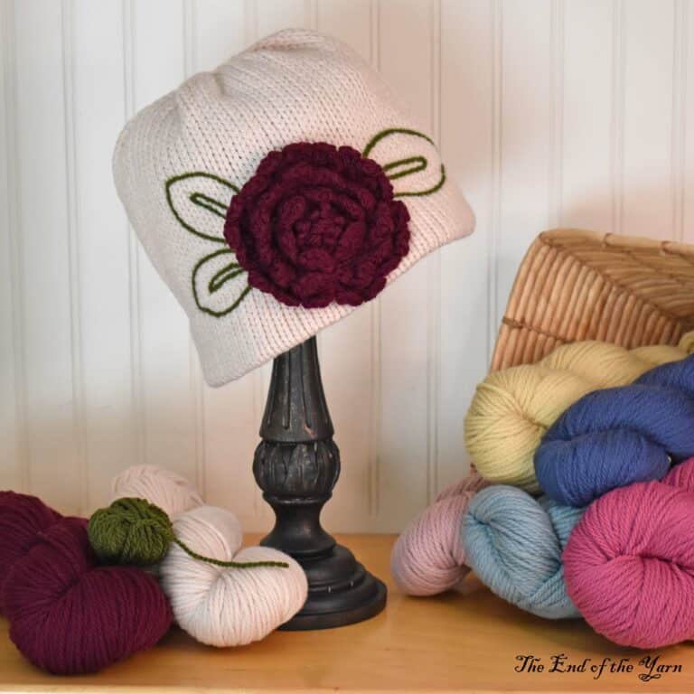 Pink hat with large flower on it.