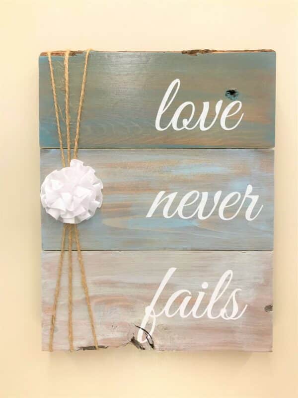 Love Never Fails Wooden Sign