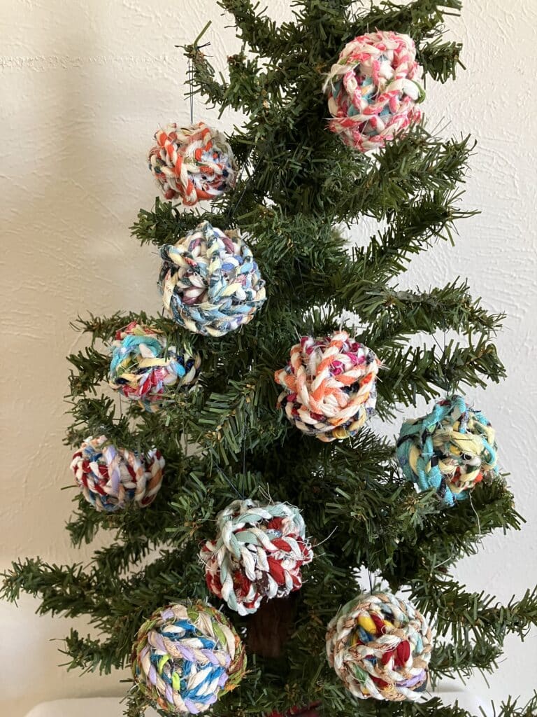 fabric twine ornaments on tree closeup