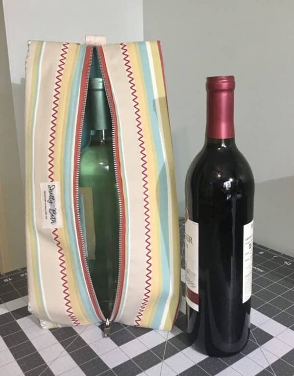 Wine bag. 1 bottle inside, 1 setting to the side.