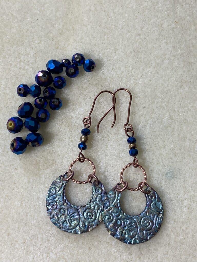 blue swirl round metal earrings with sparkly blue beads