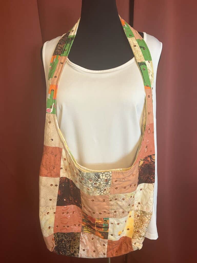 Boho purse features shades of orange patchwork design of cotton batiks. Sequins adds a touch of bling.