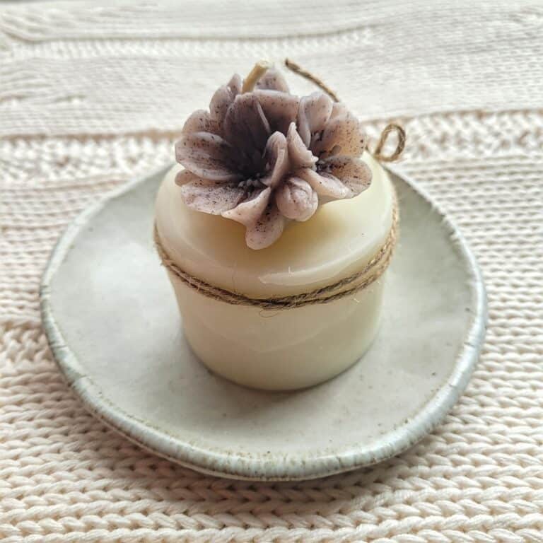 Beeswax candle with purple flowers