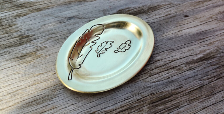 Bronze trinket dish with embossed feathe pattern