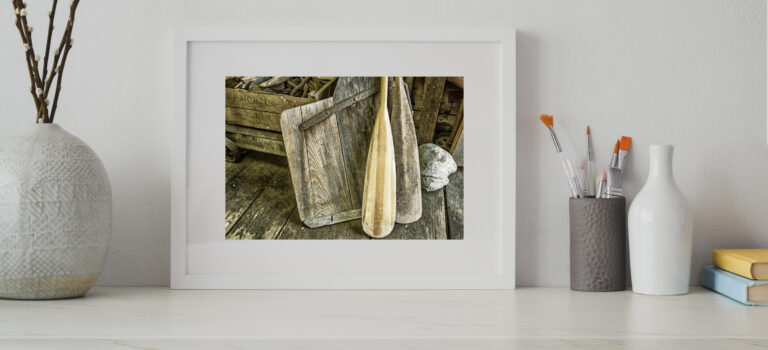 oars white picture frame on white wooden table near ceramic vase 3773416