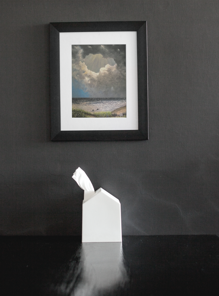 framed art print mockup on a black wall over a black table a14688