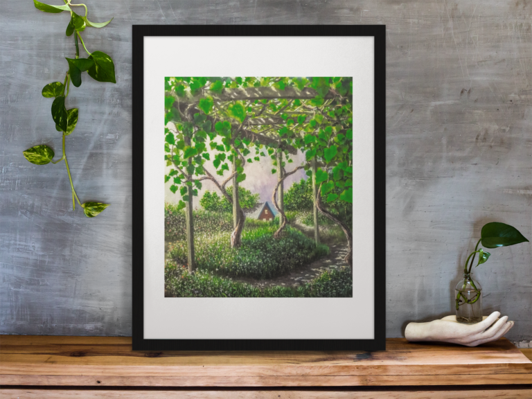 framed art print standing on a wooden desk against a concrete wall near a hand decoration a10403 13