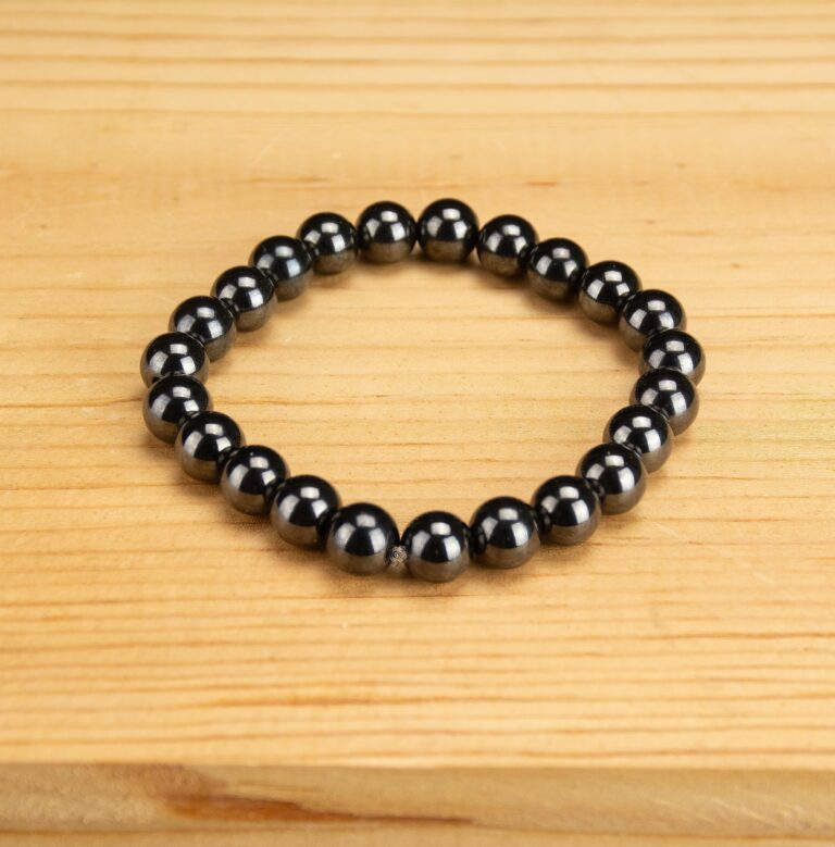 Magnetic Bracelet - 8mm black bead bracelet on a wooden background