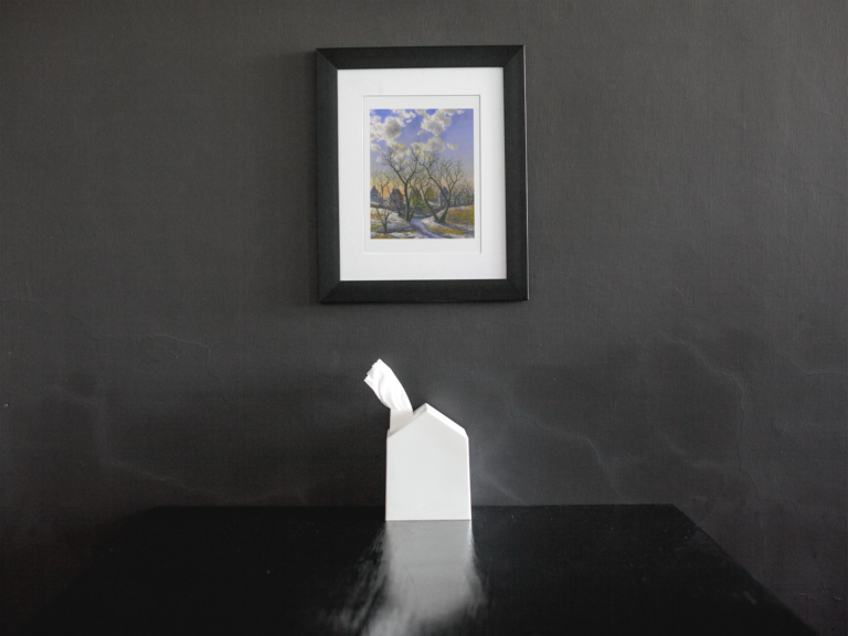 framed art print mockup on a black wall over a black table a14688