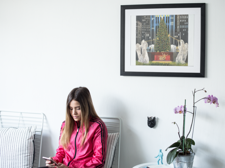 young girl sitting down near a framed art print template on a white wall a14776 angels