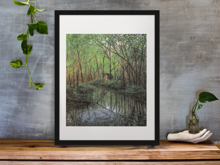 framed art print standing on a wooden desk against a concrete wall near a hand decoration a10403 1