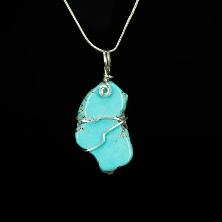Turquoise slab pendant wrapped in square Argentium Silver wire.