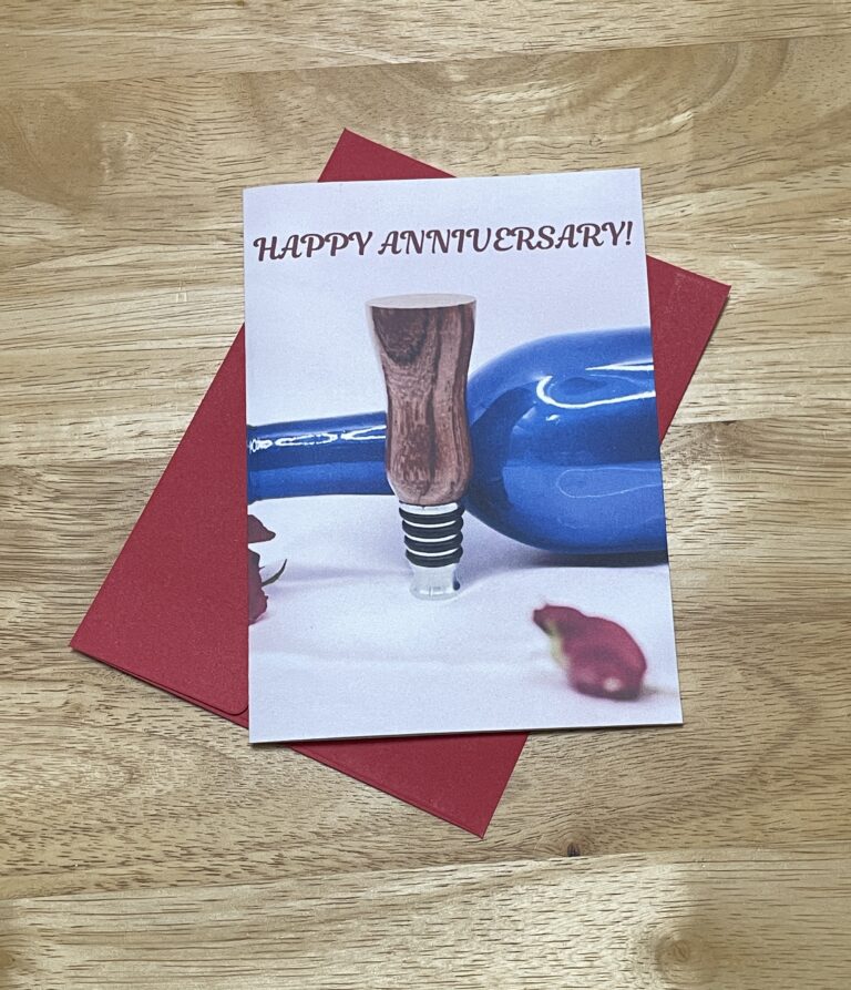 Happy Anniversary Card with blue wine bottle, red roses, bottle stopper, and red writing