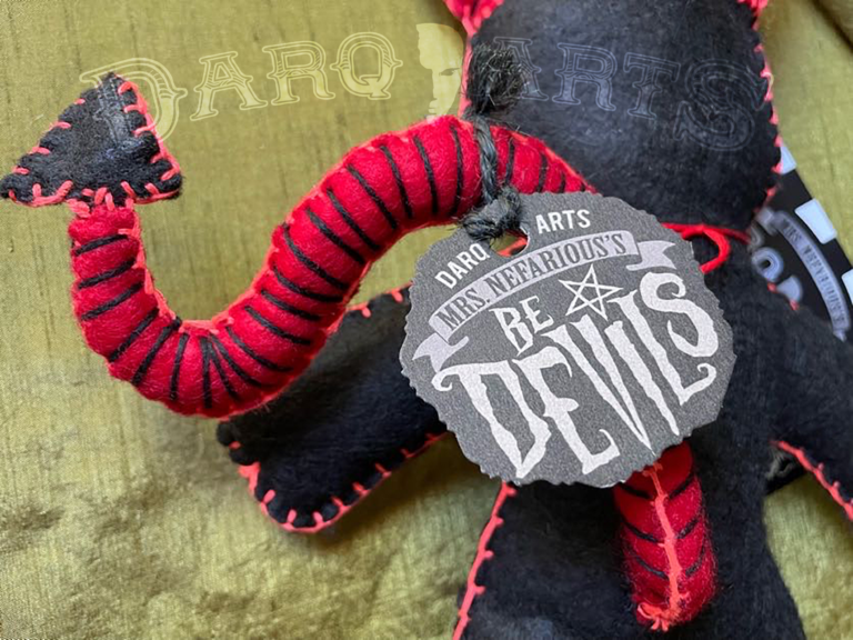Bedevils. Name Bedlam. Black soft felt body with bright red accents. Back view close up.