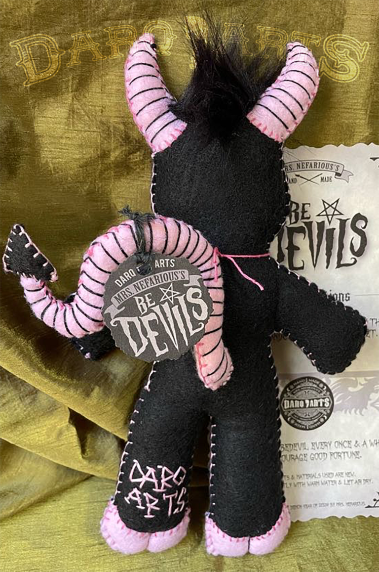 Bedevils. My name is Chagrin. I have a black felt body with piggy pink accents. Back view.