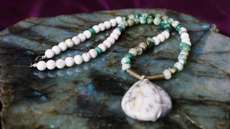 White and green moss agate necklace on stone
