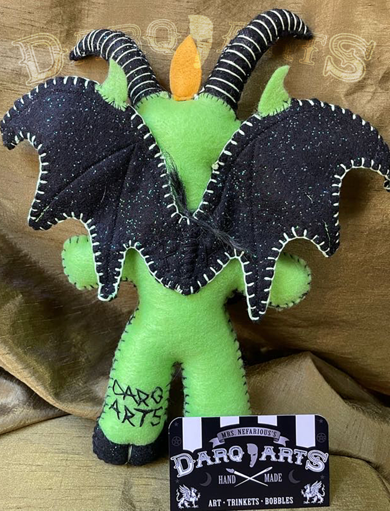 Baphomet back full view of adorable soft felt poppet handmade by Mrs. Nefarious of Darq.arts. Bright green body with sparkle black wings, horns, hooves and tummy. Eternal flame on top of head.