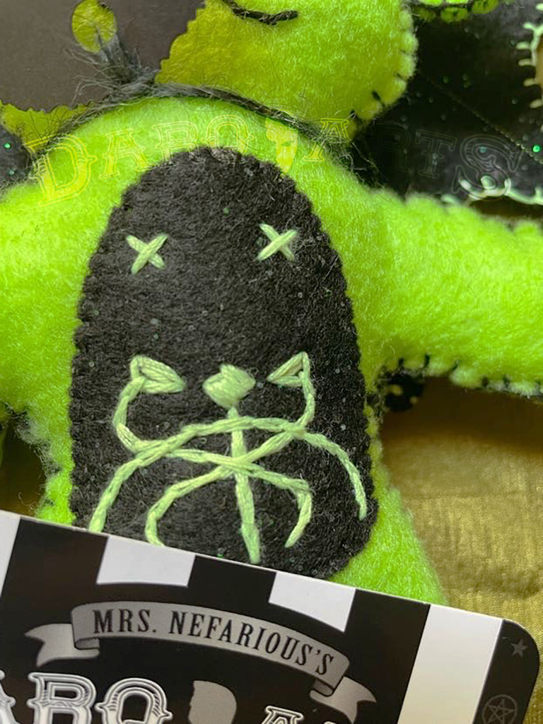 Baphomet bright green. Front view close up of hand stitched snake emblem on tummy.