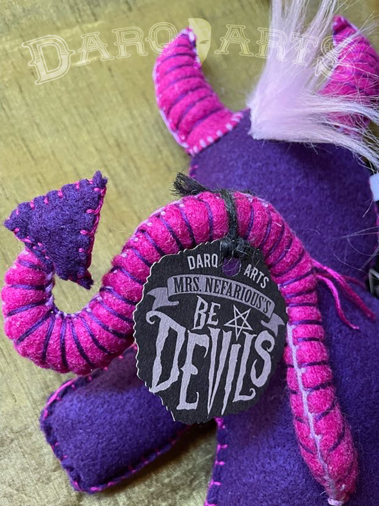 Bedevils. Backside view. My name is Harum. I have a purple felt body with hot pink accents. Back side close up.