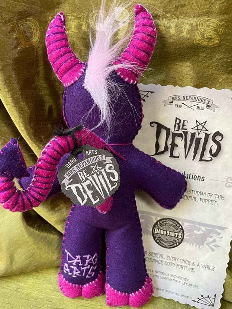 Bedevils - Harum. Purple soft felt body with hot pink horns, tail, hooves and reversed pentagram. Full back view.