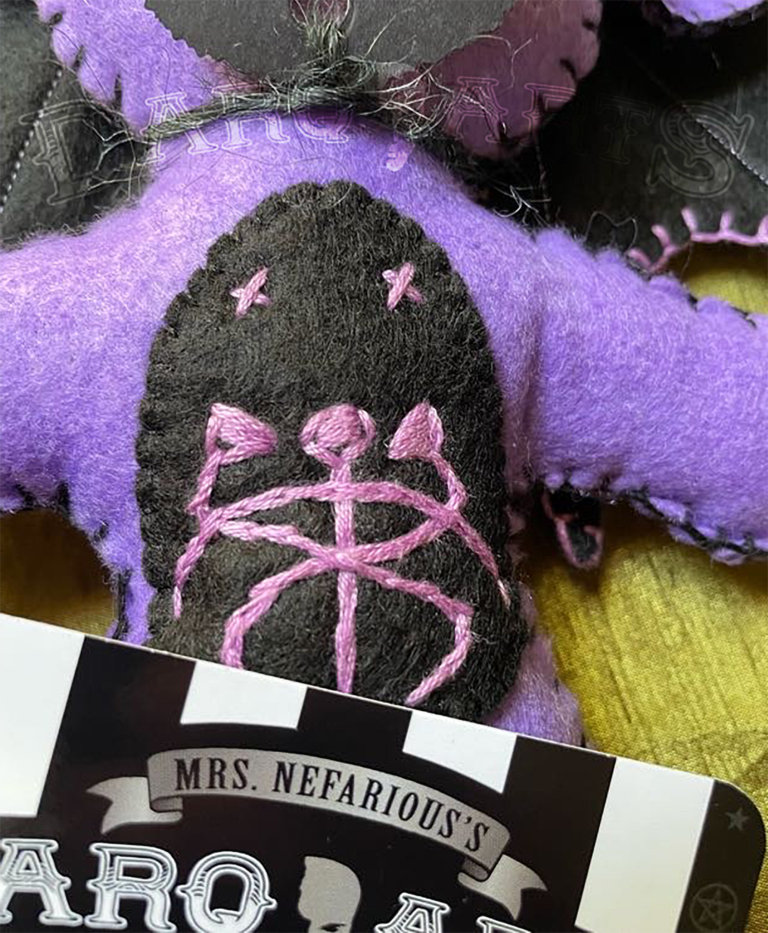 Baphomet Purple. Front view close up of hand stitched snake emblem on tummy.