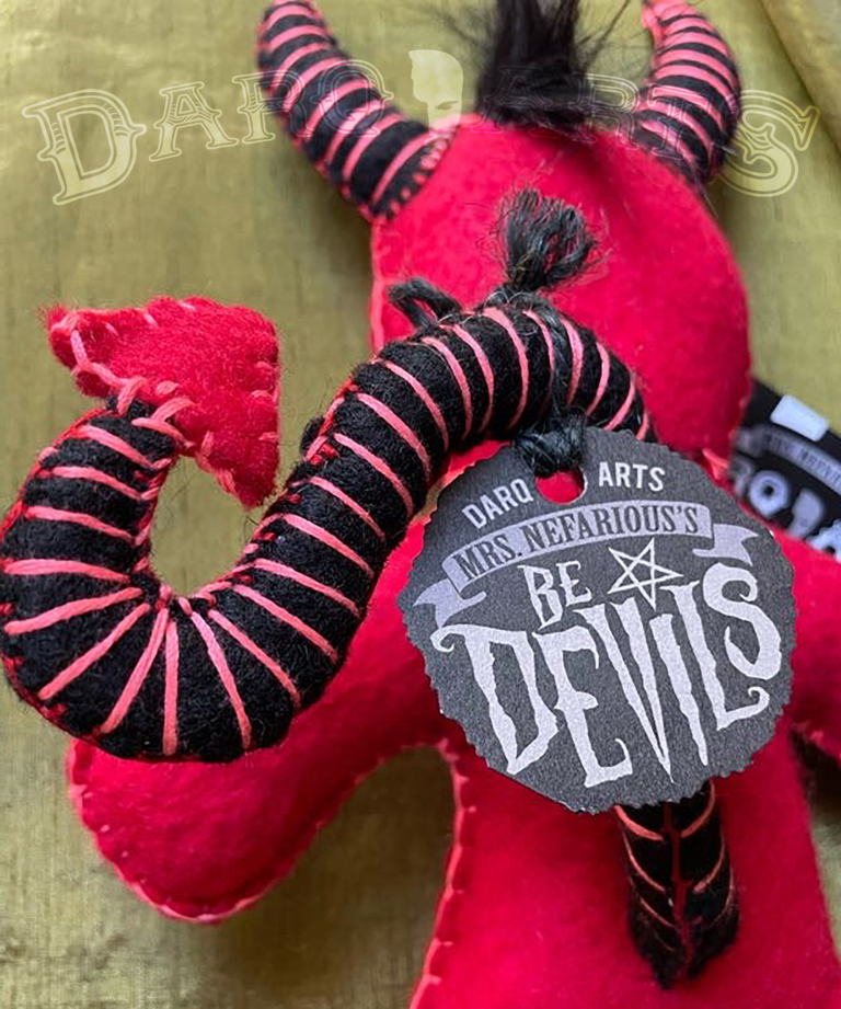 Bedevils - Sinamen. Bright red soft felt body with black horns, tail, hooves and reversed pentagram. Close up back view.