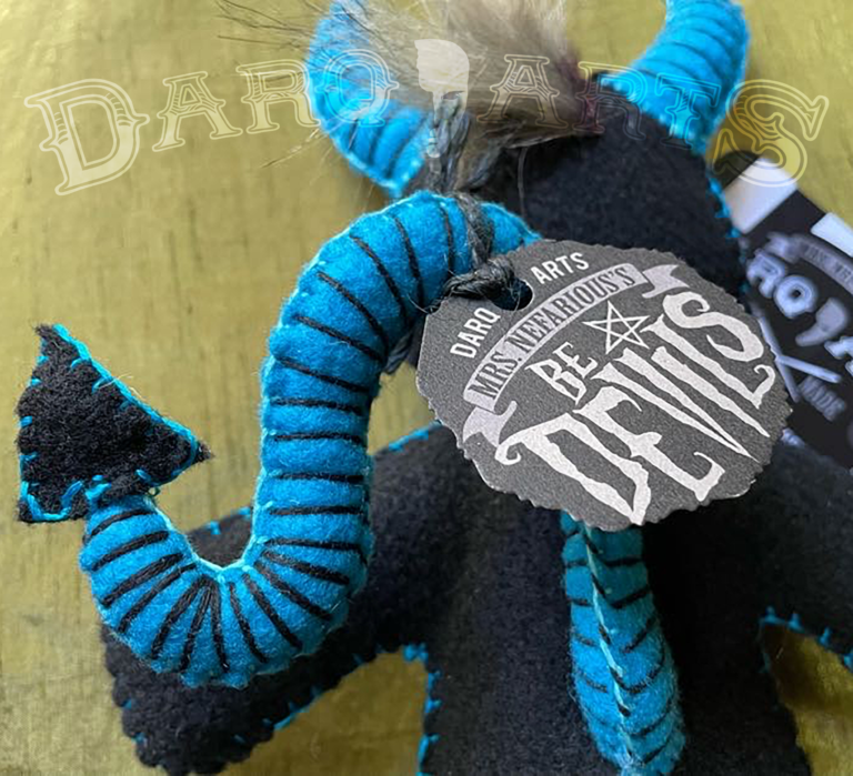Bedevils - Zonk. Black soft felt body with cyan horns, tail, hooves and reversed pentagram. Close up back view.