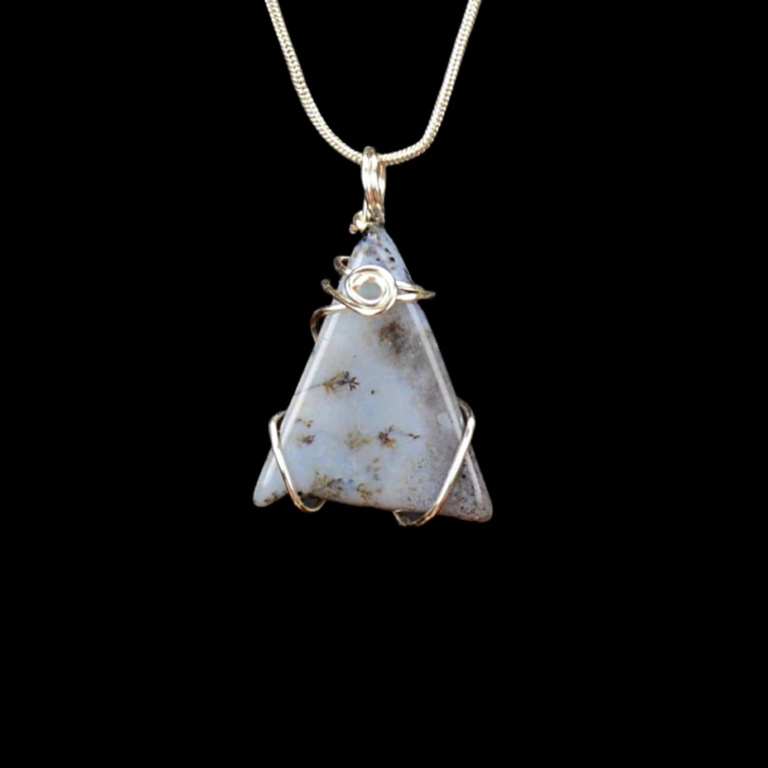 Gray stone with dendrite inclusions. The triangular stone pendant hangs from a silver snake chain.