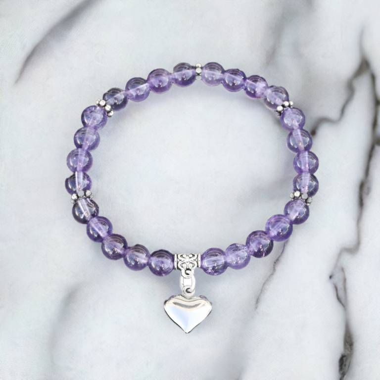 Amethyst 66mm bead bracelet with a heart chain on a marble countertop.