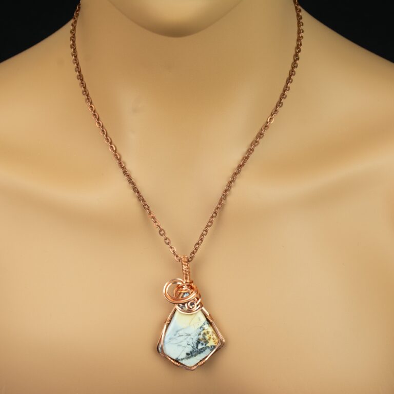 Dendritic maligano jasper pendant with copper chain on a mannequin.