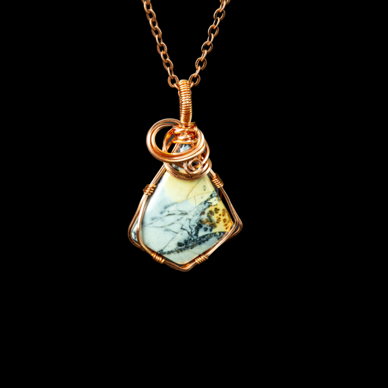 Diamond shaped dendritic maligano jasper pendant wrapped in copper wire. This stone has shades of white, black and yellow. There is a copper swirl near the bail.