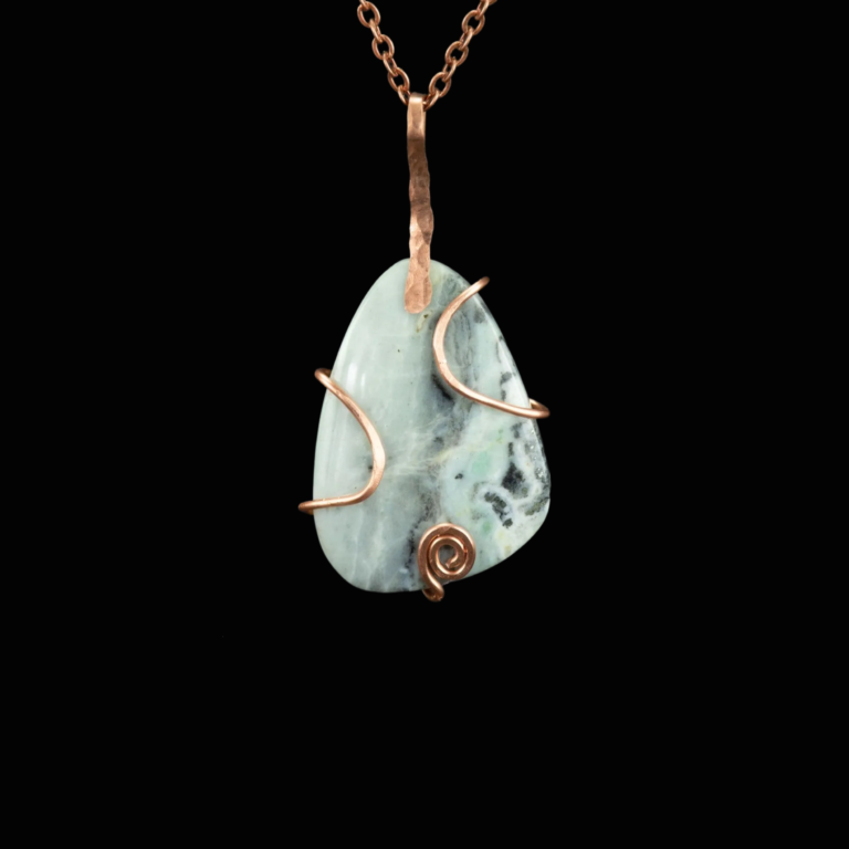 Handcrafted Amazonite pendant. This irregular teardrop shaped gray and blue stone is captured in hammered copper wire.