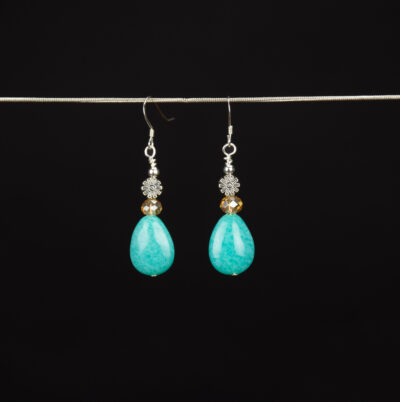 Amazonite teardrop earrings. The teardrop shaped focal stones are topped with champagne color Czech glass beads and silver flower shaped beads. The earrings have Sterling Silver French ear wires.
