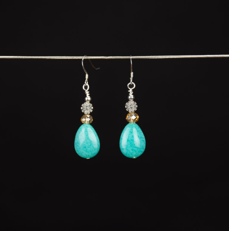 Amazonite teardrop earrings. The teardrop shaped focal stones are topped with champagne color Czech glass beads and silver flower shaped beads. The earrings have Sterling Silver French ear wires.