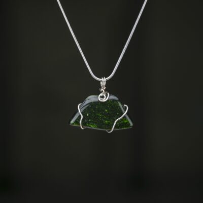 Green goldstone pendant minimally wrapped in silver craft wire. This is shown on a silver snake chain.