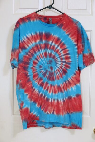 A red and blue tie-dye shirt in a spiral pattern. Extra Large.
