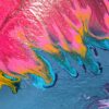 A close-up of the hints of shimmery metallic blue along the bottom edge of the main feather.