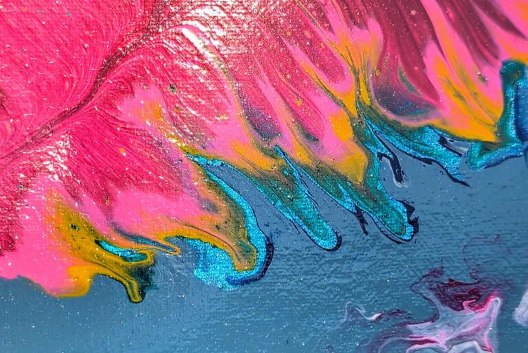 A close-up of the hints of shimmery metallic blue along the bottom edge of the main feather.