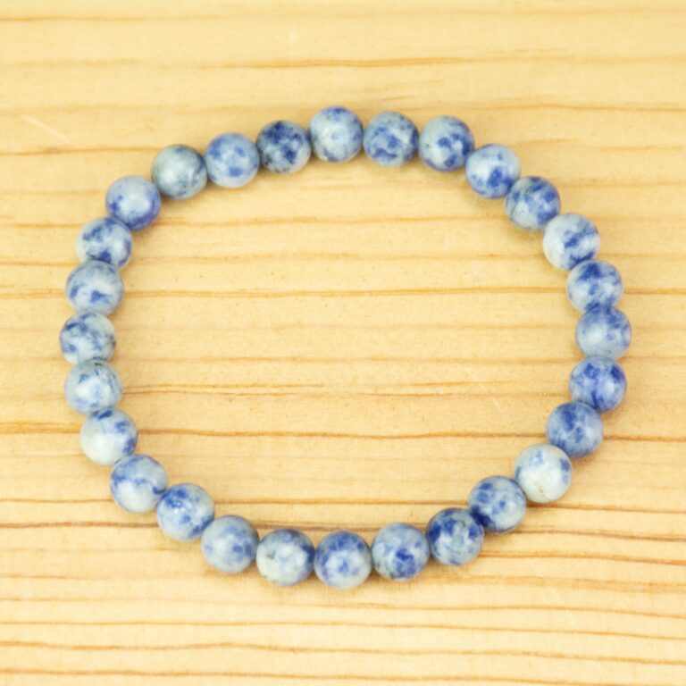 6mm blue spot jasper on a wooden background