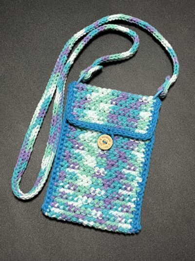 Blue/purple/white variegated cotton crossbody bag. Button closure. Shoulder strap is adjustable and removable.
