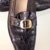 Ferragamo black loafers gold buckle close up