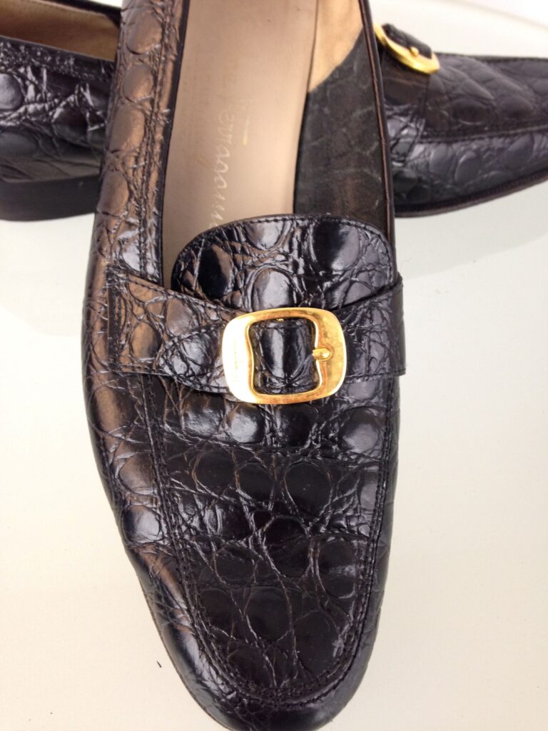 Ferragamo black loafers gold buckle close up