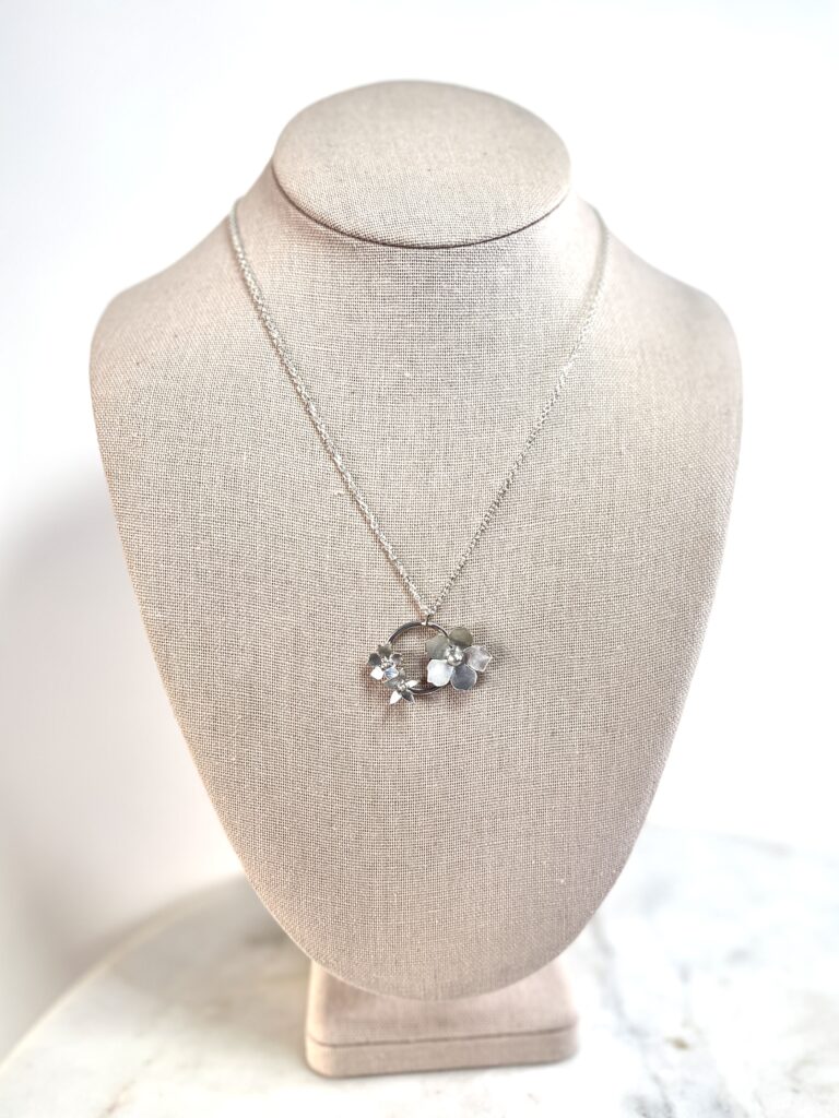 sterling silver flower wreath necklace on linen bust