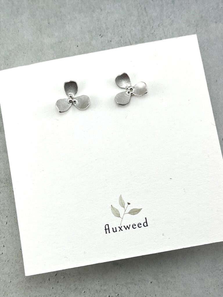 sterling silver orchid flower stud earrings on card