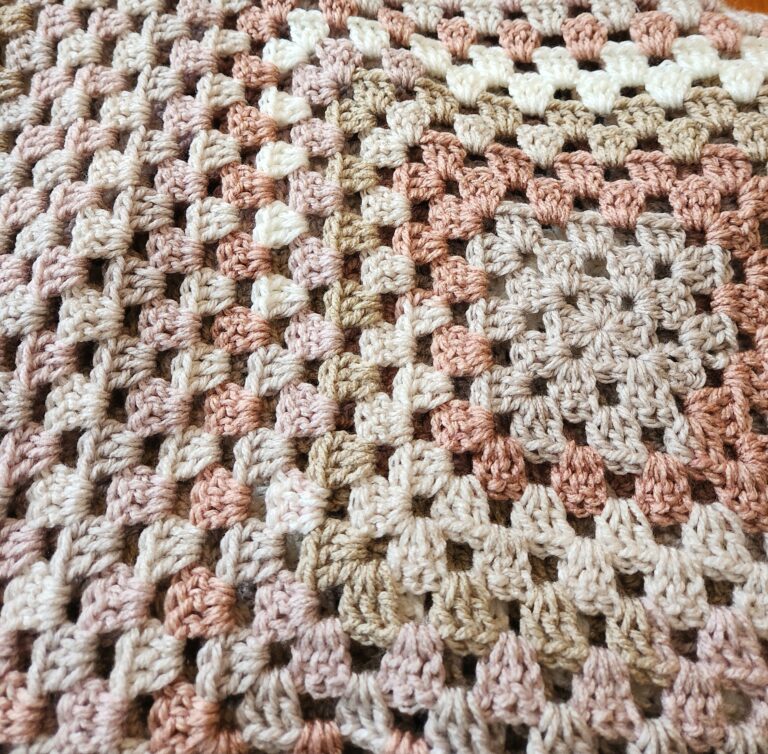 Crochet Shawl - Granny Stitch with a Diamond Pattern Back 3 Close up of granny stitches on a shawl in varying colors of cream, pink and light brown